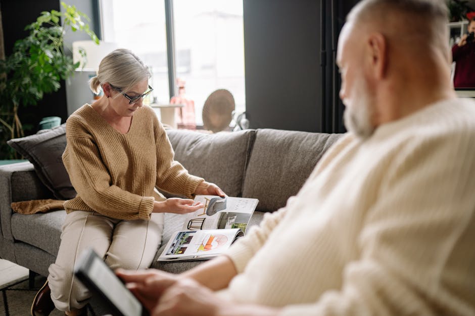 Senior couple enjoying a cozy afternoon reading magazines in their modern living room.