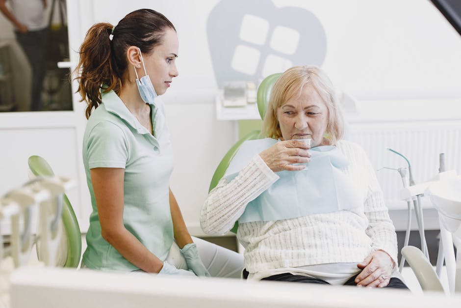 A female dentist assists a senior patient in a dental clinic, ensuring comfort and care.