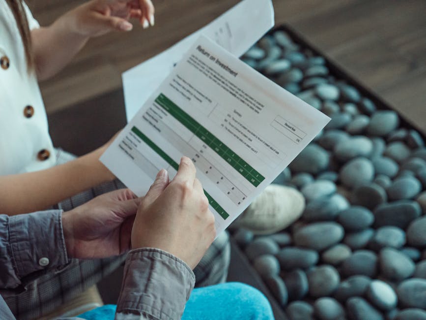 Two people discussing a financial document showing return on investment data.