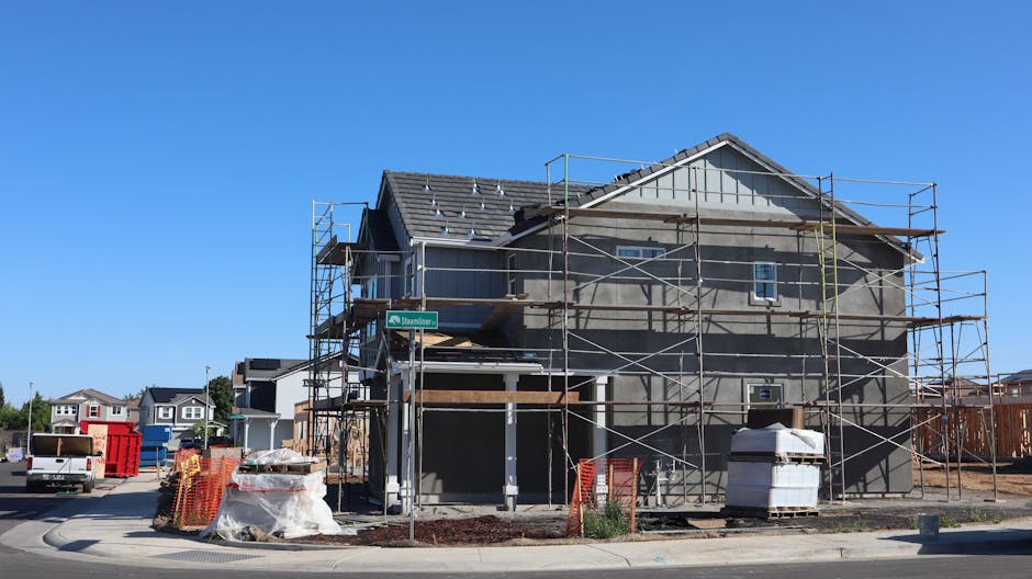 A new housing development under construction in Elk Grove, California with visible scaffolding and materials.