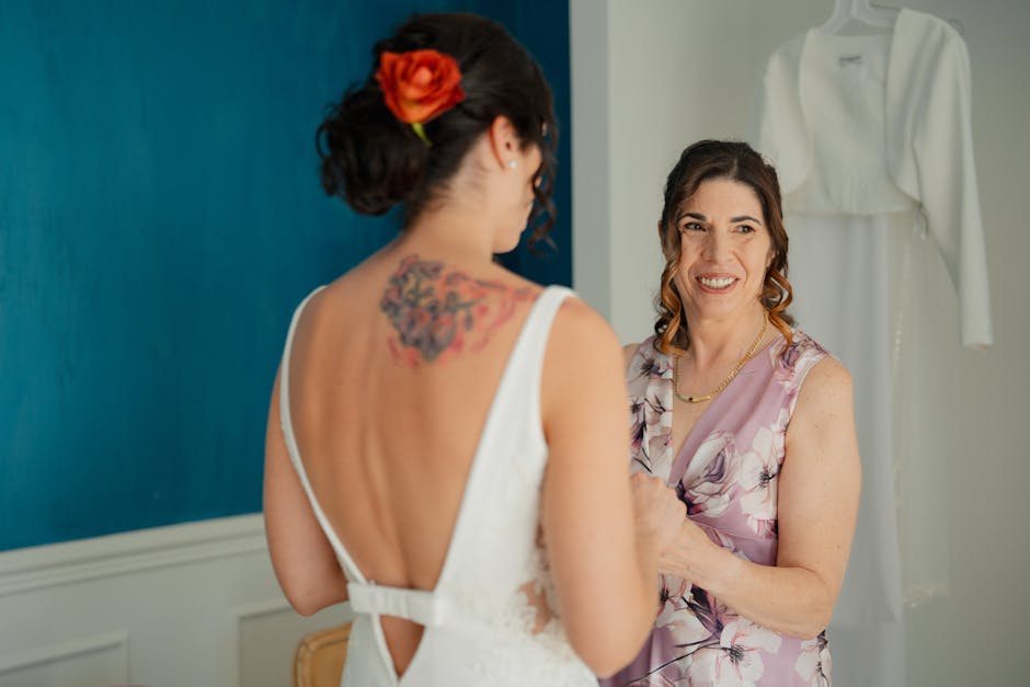 Bride getting ready with a bridesmaid in a dressing room, showcasing joyful wedding preparations.