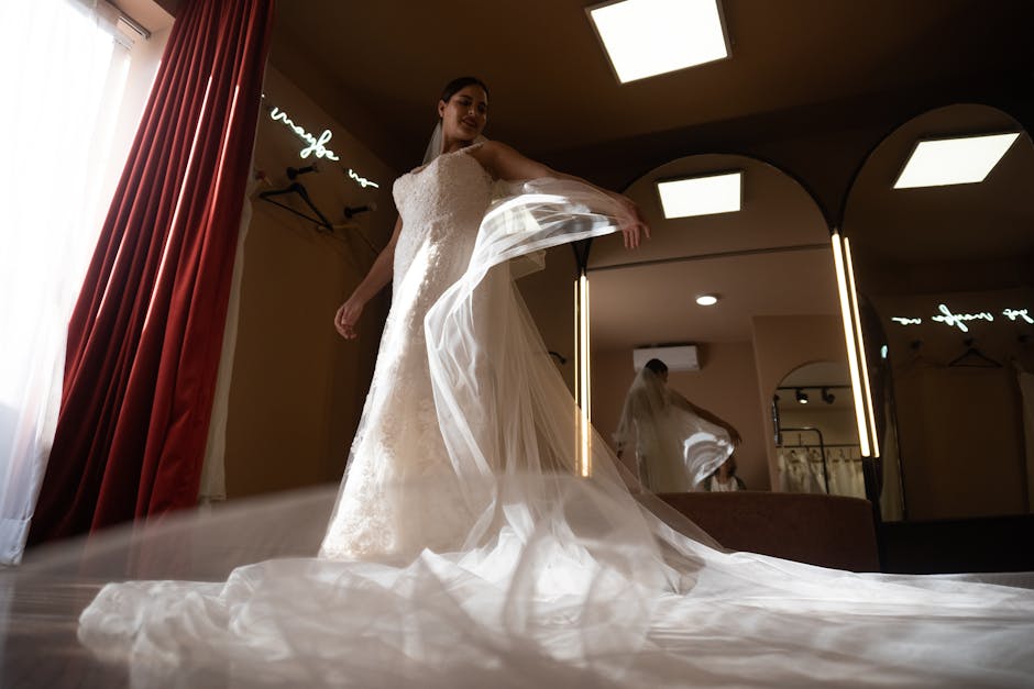 Bride in a wedding dress admiring her reflection in a chic dressing room, exuding elegance and anticipation.