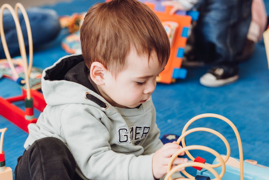 A young child playing with an educational toy indoors, capturing a moment of focused playtime.
