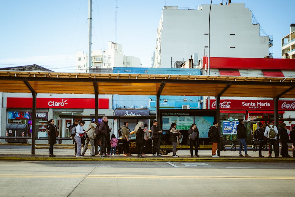A diverse group of people waiting at a bus stop in Buenos Aires, Argentina.