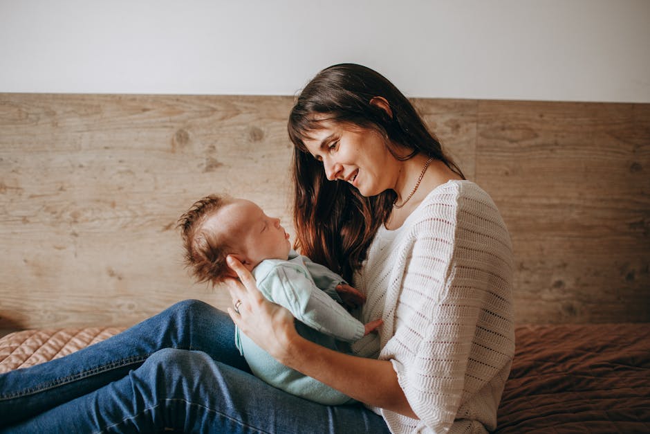A loving mother embraces her baby in a cozy indoor setting, showcasing warmth and affection.