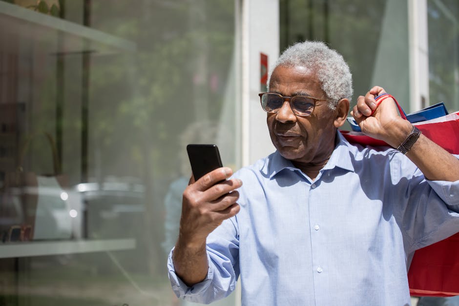 Elderly man with red shopping bags using smartphone outdoors in Portugal.