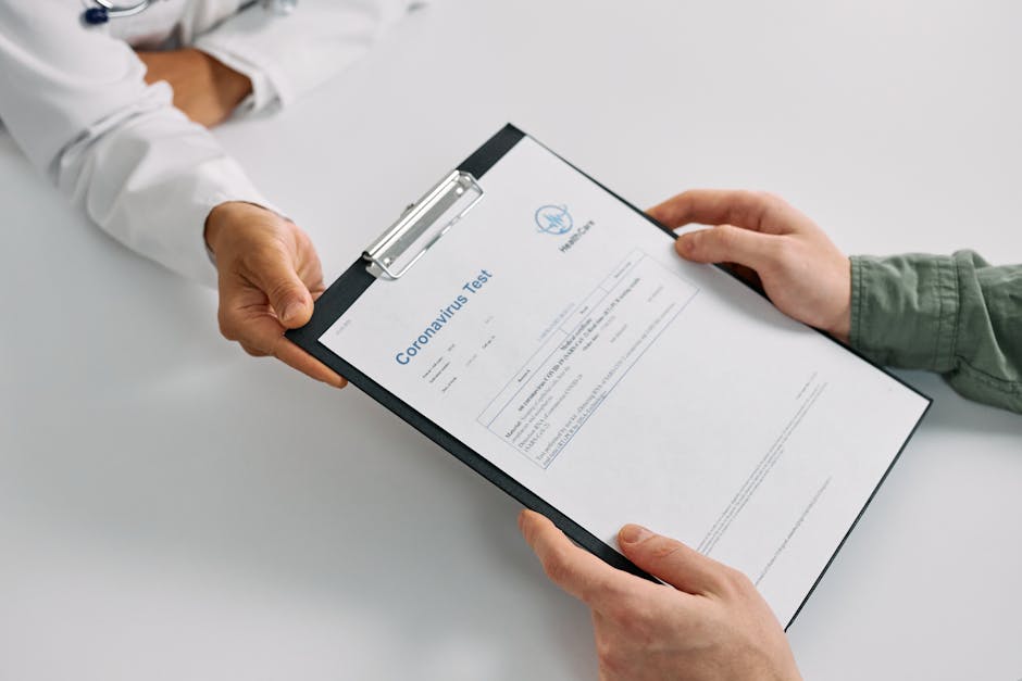 A doctor hands over coronavirus test results to a patient during a consultation in a medical clinic.