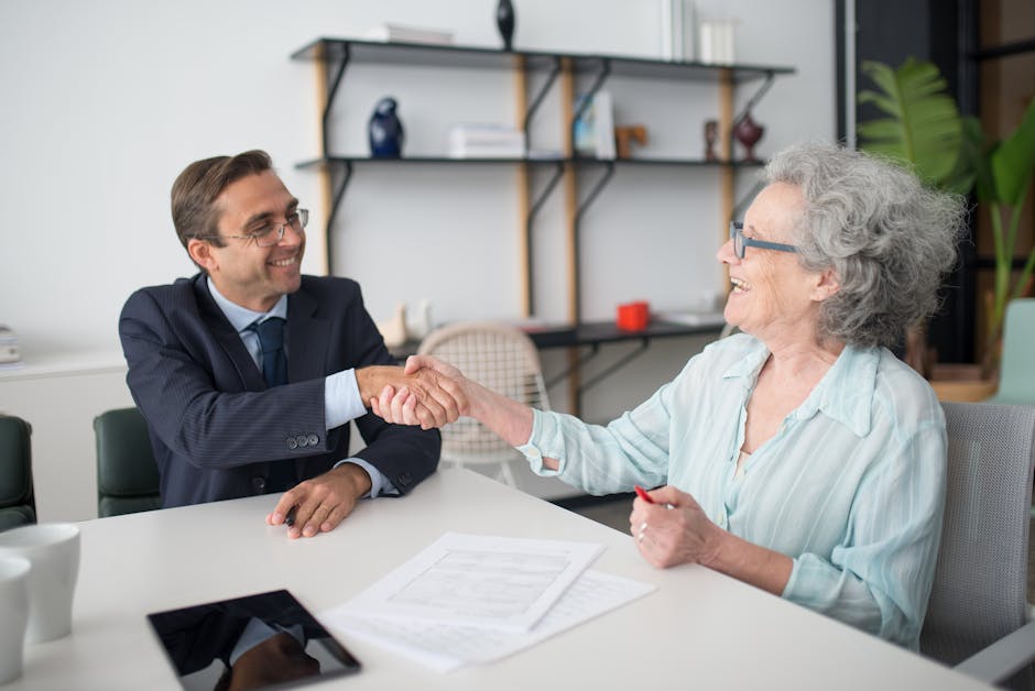 Professional business meeting with a handshake between consultant and client at an office.