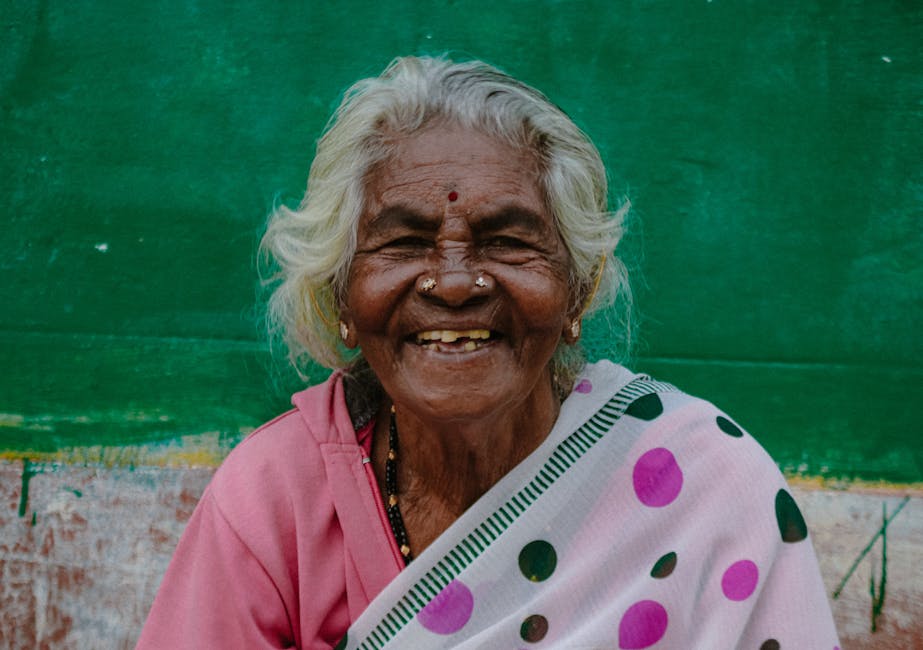 Elderly South Asian woman with a joyful smile, wearing traditional attire in Mandya, India.