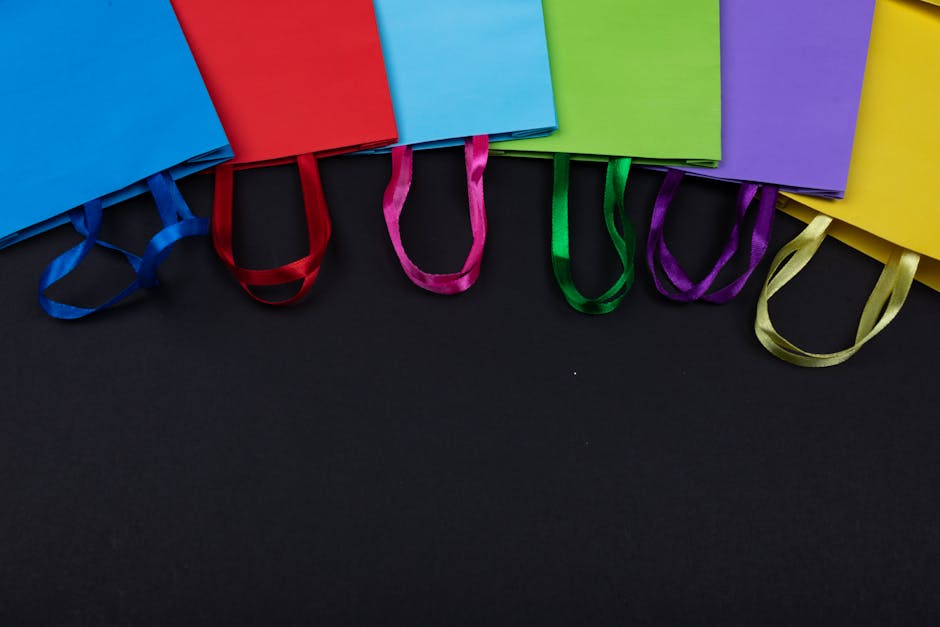A vibrant arrangement of colorful shopping bags displayed on a black background.
