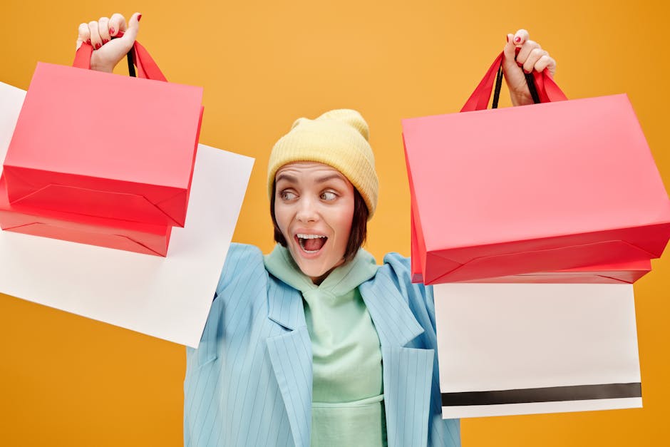 Excited woman holding colorful shopping bags, enjoying a shopping spree.