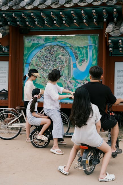 Family studying a map in Andong, South Korea while enjoying a cycling tour together.