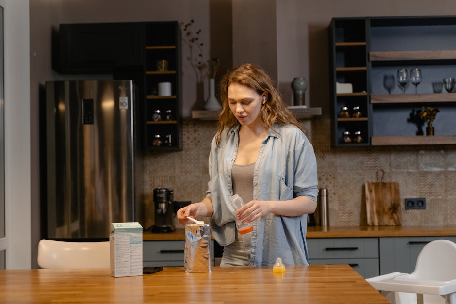 Woman preparing baby formula in a cozy kitchen setting, embodying modern motherhood.