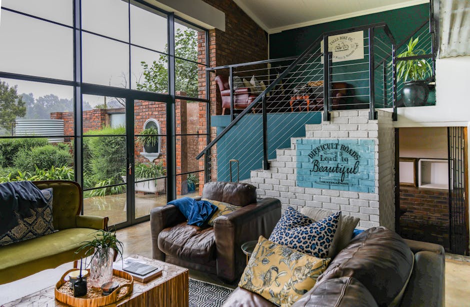 Stylish living room interior featuring large windows, modern decor, and a cozy seating area.
