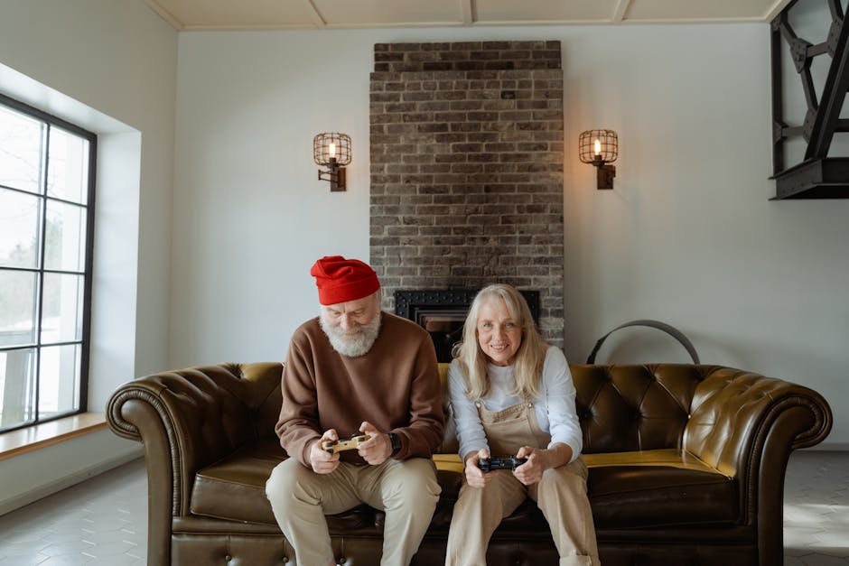 Elderly couple playing video games on the couch in a cozy living room setting.