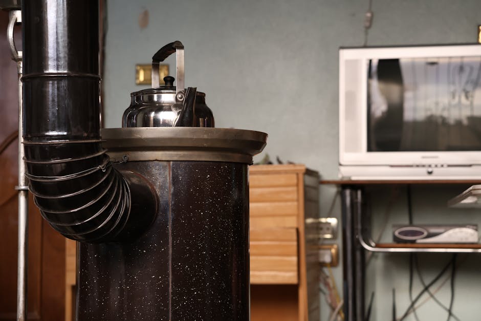 An vintage stove with a kettle beside a retro TV set, creating a nostalgic indoor ambiance.
