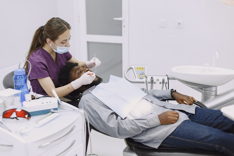 Female dentist performing a dental checkup on a male patient in a modern clinic.