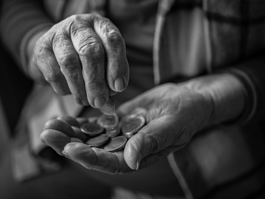 A close-up of elderly hands counting coins, portraying poverty and financial insecurity.