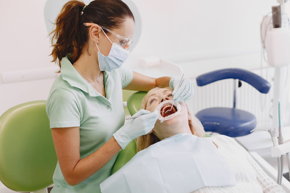 Female dentist examining senior woman's teeth in a dental clinic setting.