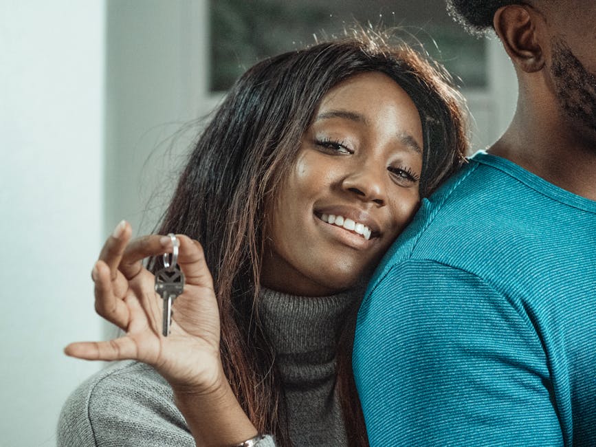 A joyful couple celebrating their new home purchase by holding keys.