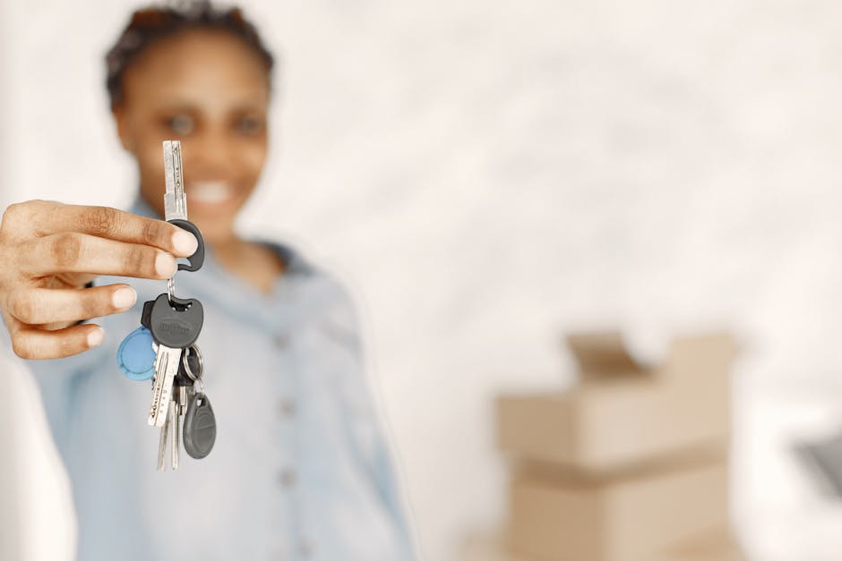 Close-up of a woman holding keys with a blurred background, symbolizing a new home or real estate concept.
