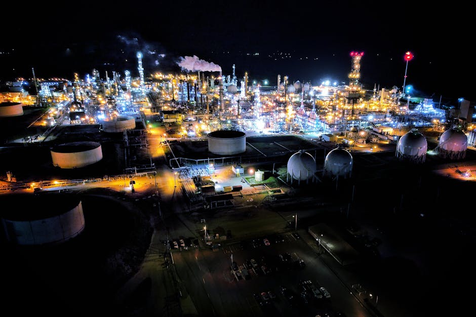 Stunning aerial view of a brightly lit refinery in El Dorado, Kansas showcasing industrial architecture.