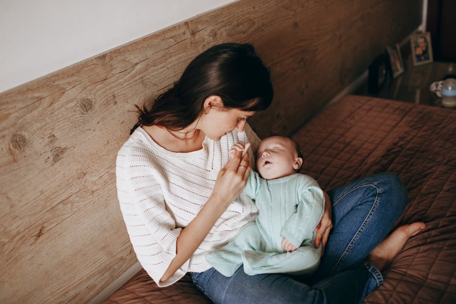 A loving mother holds her sleeping baby in a peaceful home setting. Intimate moment captured indoors.