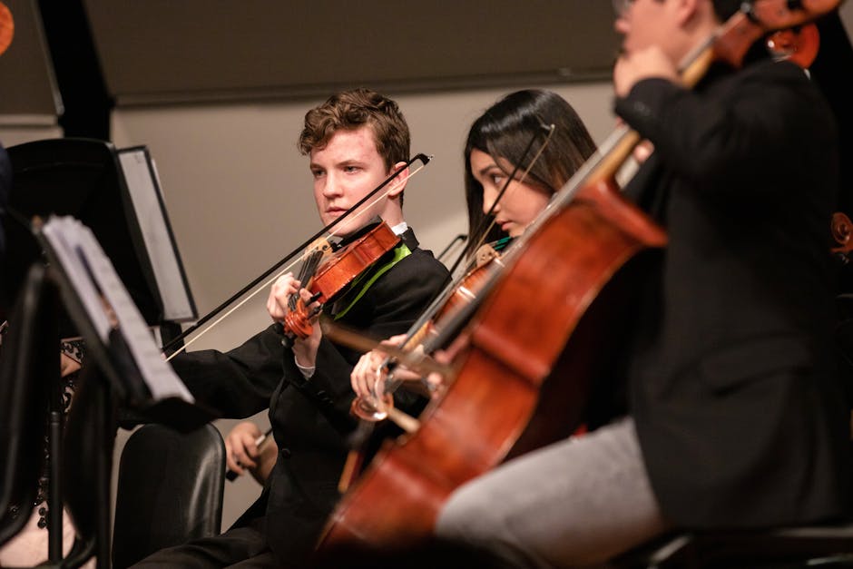 A captivating live orchestra performance featuring young musicians playing string instruments on stage.