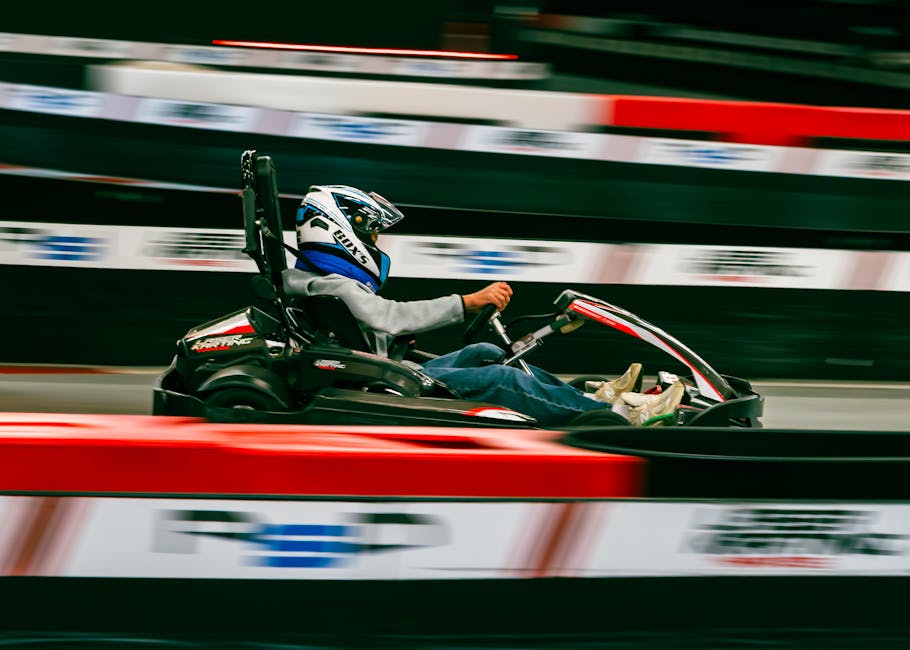 Dynamic view of a racer during indoor go-karting at high speed in Nantes, France.
