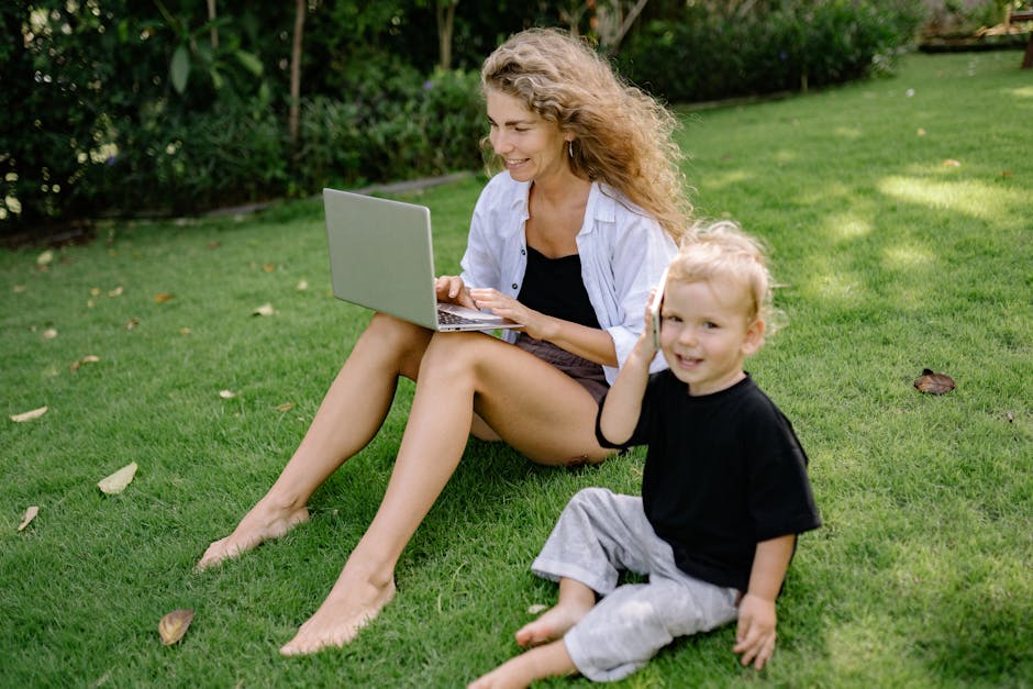 A woman and her child bonding on the lawn with a laptop in Bali, Indonesia.