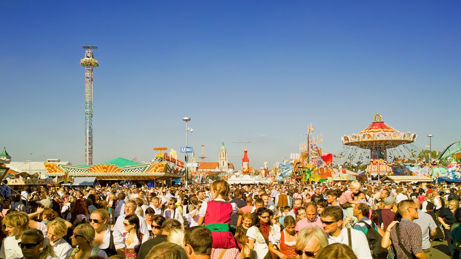 A lively scene at a crowded amusement park during the day.