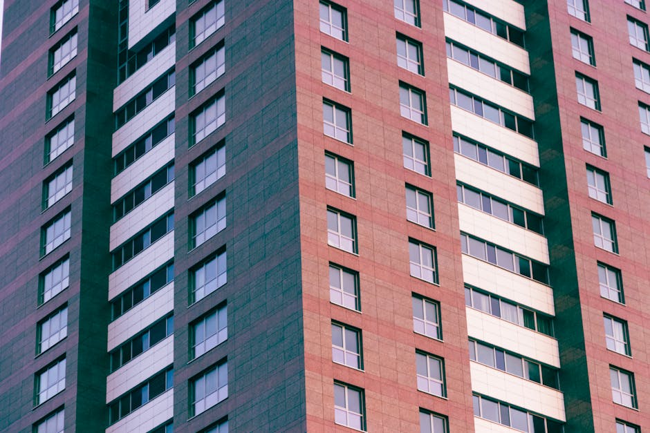Close-up of a modern high-rise building with glass windows and geometric patterns.