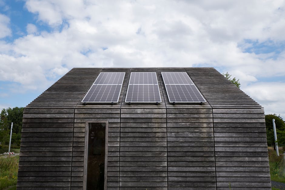 Wooden house with solar panels under a cloudy sky, promoting sustainable energy.