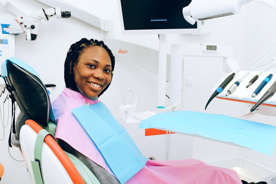 A smiling woman in a dental chair, showcasing modern dental healthcare environment.