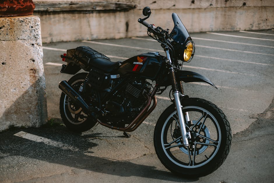 A classic black Honda motorcycle parked in an urban Charlotte, NC parking lot.