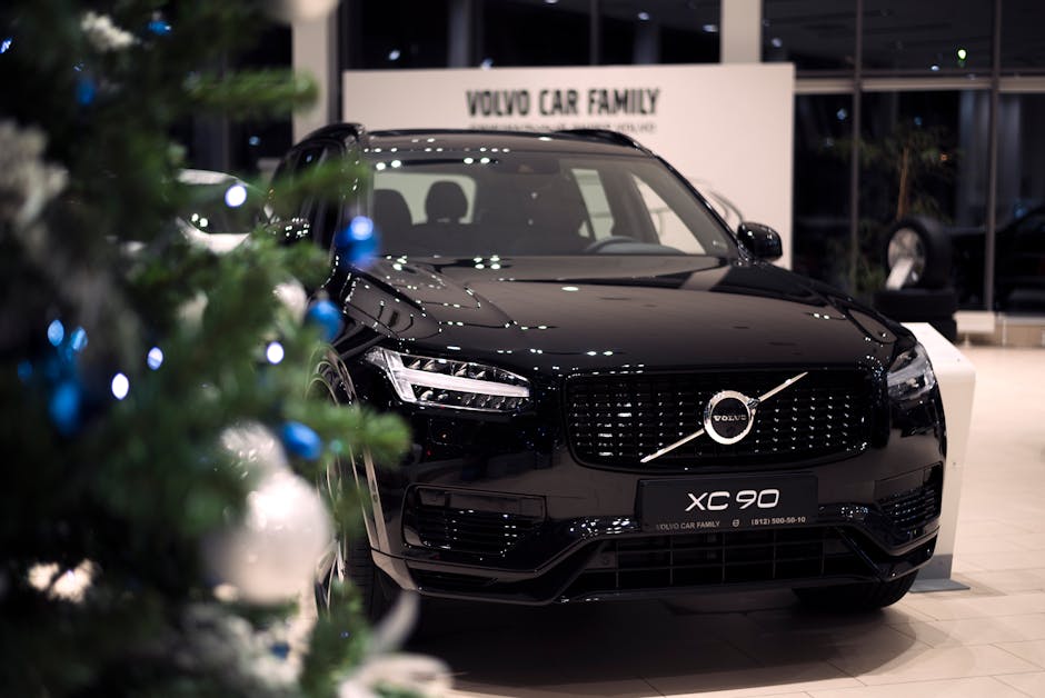 Stylish black Volvo XC 90 displayed in a festive showroom with a Christmas tree.