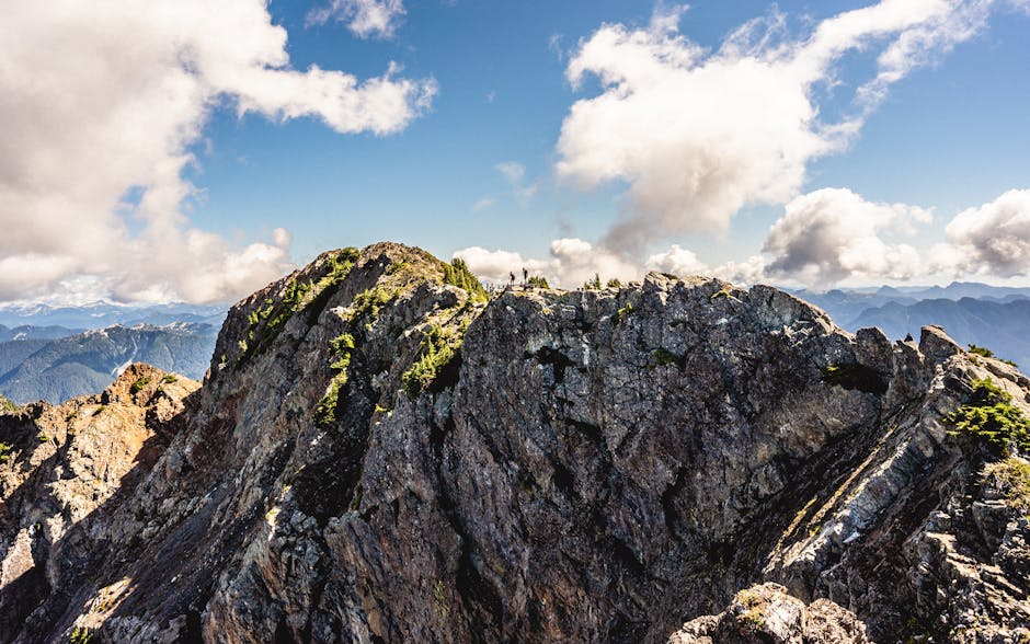 A breathtaking view of rocky mountain peaks under a vivid blue sky in British Columbia, Canada.