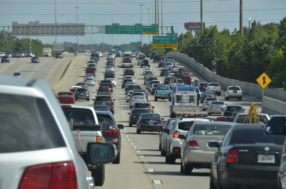 Dense traffic on an urban expressway during the day, showcasing congestion and vehicles.