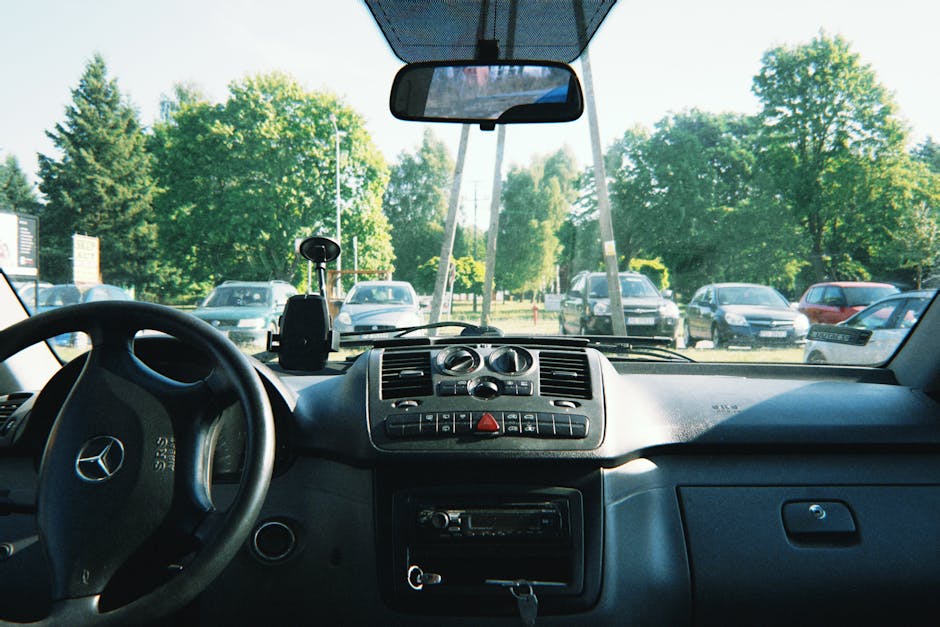 Dashboard and interior view of a parked Mercedes in Poznań, Poland.