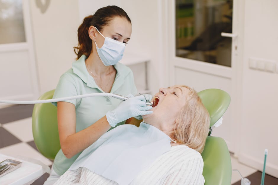 A female dentist provides dental care to an elderly patient in a modern clinic setting.