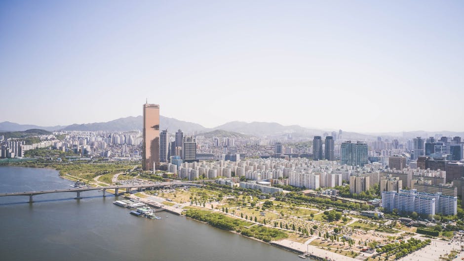 Stunning aerial view capturing Seoul's skyscrapers and river under clear skies.