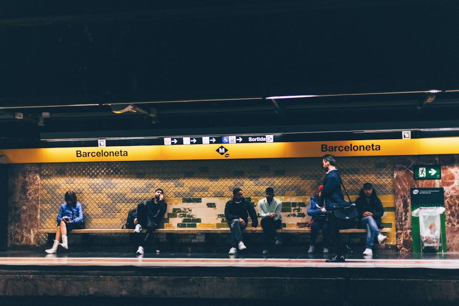 Commuters wait at Barceloneta Metro station in Barcelona, Spain, showcasing urban daily life.