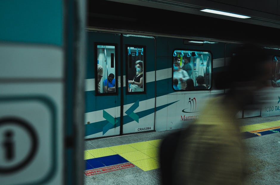 A busy subway platform with commuters and a subway train, displaying modern urban transport.