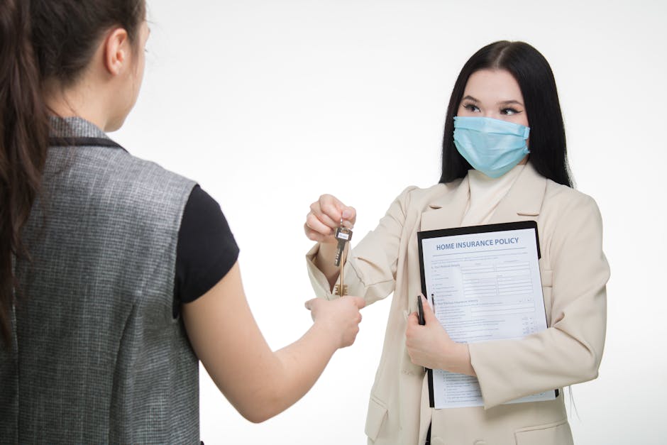 Real estate agent in a face mask hands keys to a client, illustrating safe business practices.