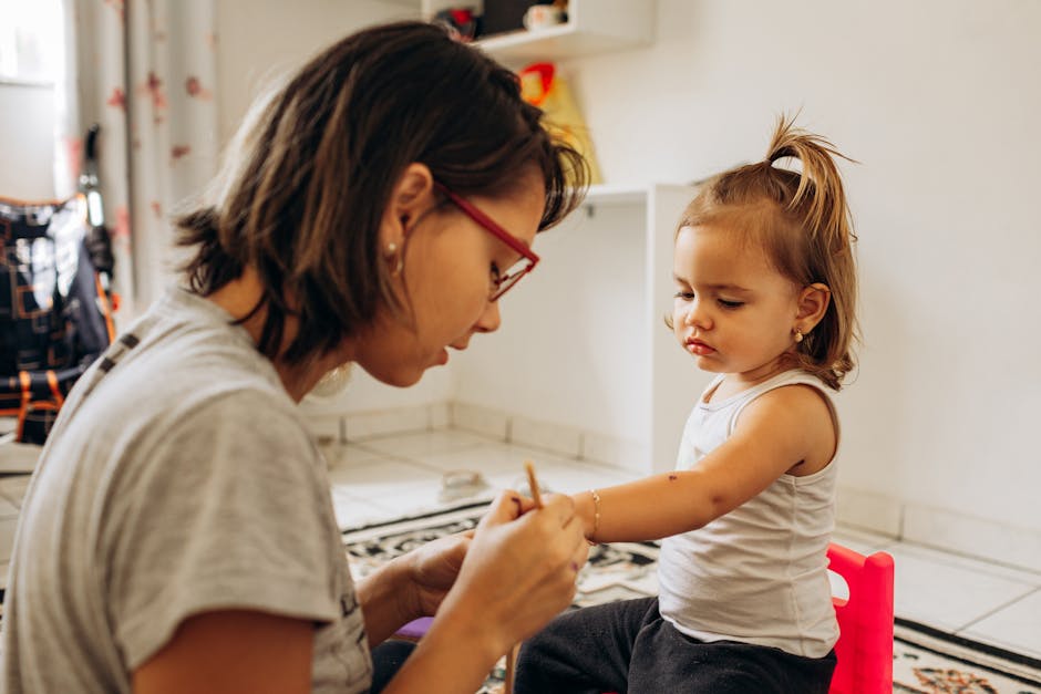 A mother and daughter bond while crafting indoors, showcasing love and creativity.