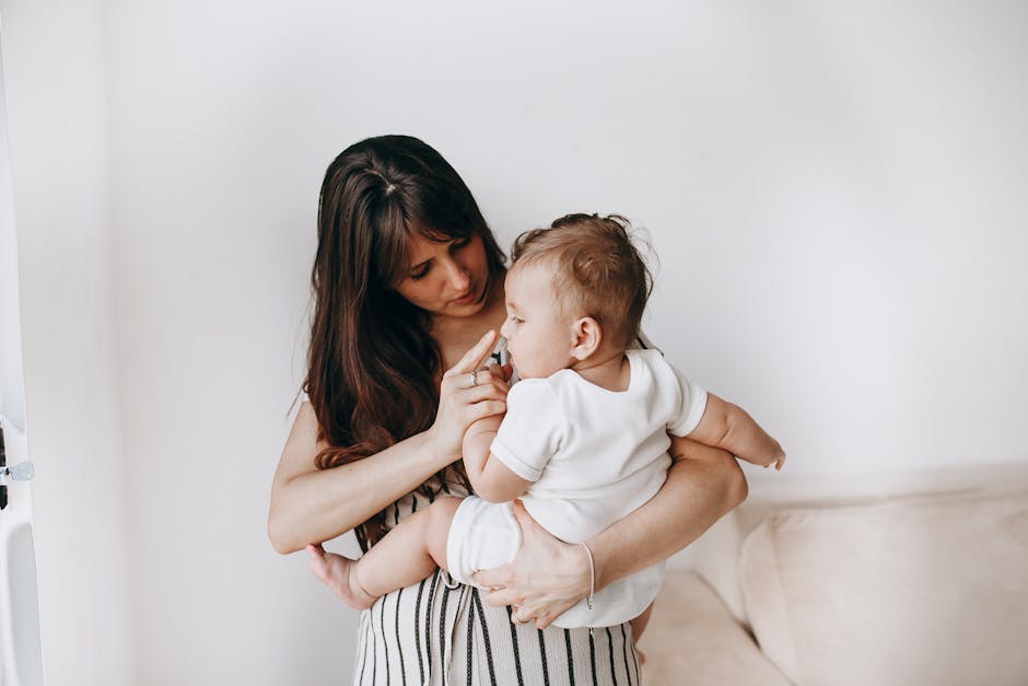 Tender moment between a mother and her baby in a cozy home environment promoting bond and care.