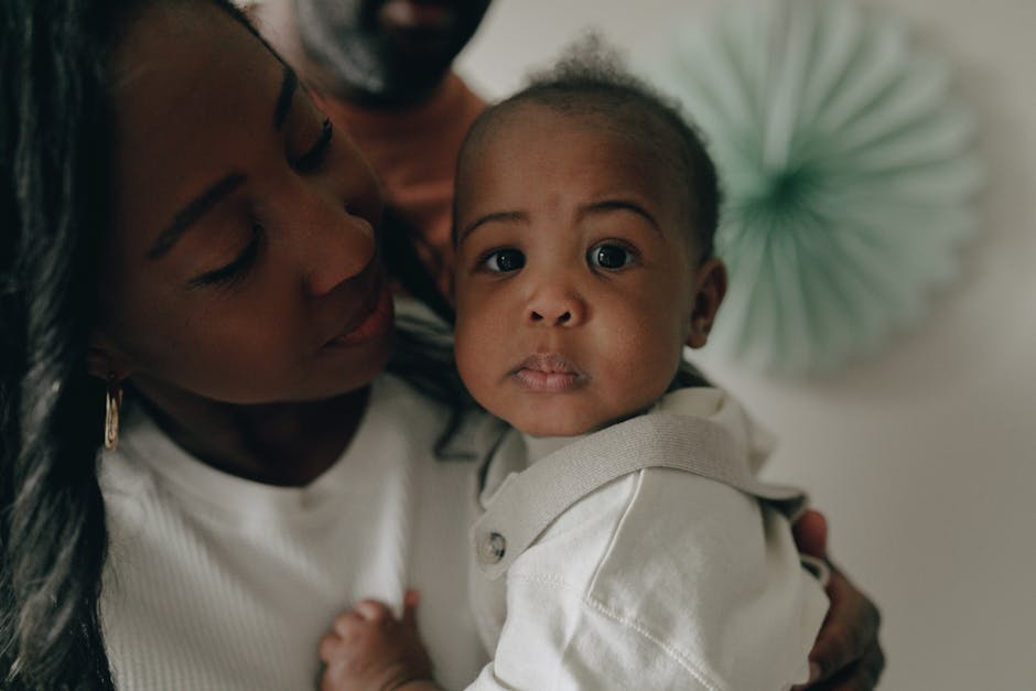 Tender moment between a mother and baby, capturing love and curiosity.
