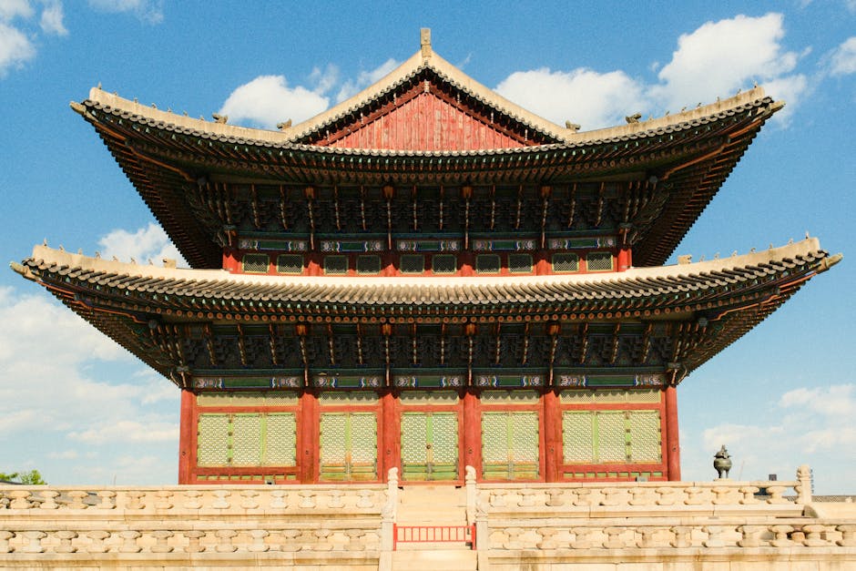 Front view of Gyeongbokgung Palace under a bright blue sky, showcasing traditional Korean architecture.