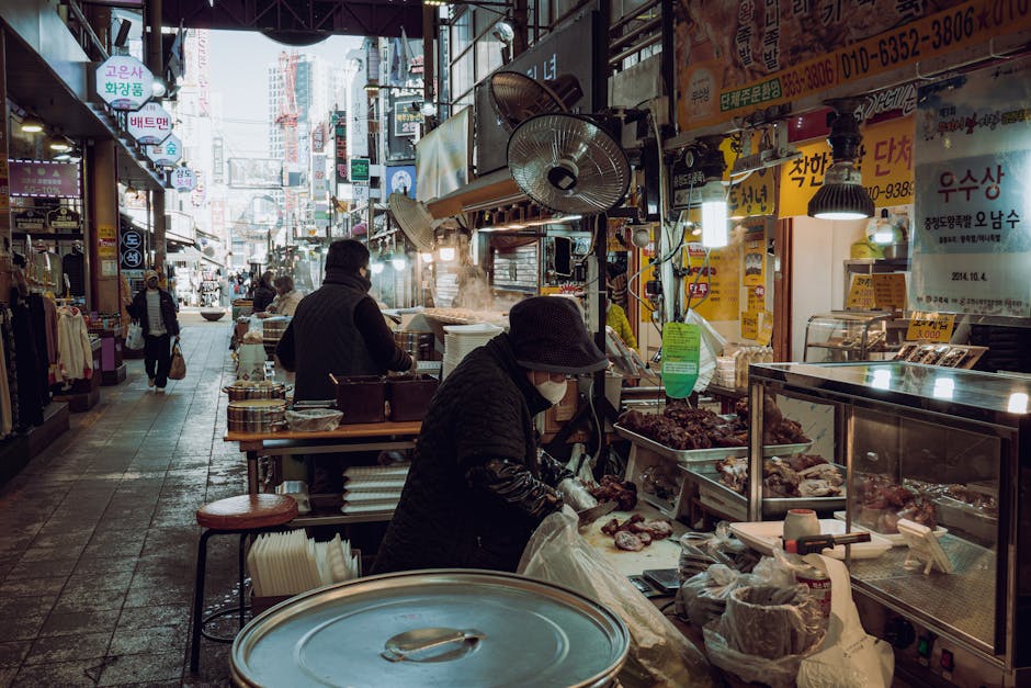 A bustling market scene in Guri-si, showcasing local vendors selling food and goods.