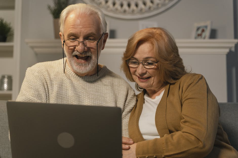 Smiling senior couple enjoying a video call on their laptop at home.